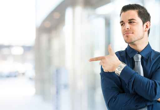 Businessman pointing his finger to the copy-space